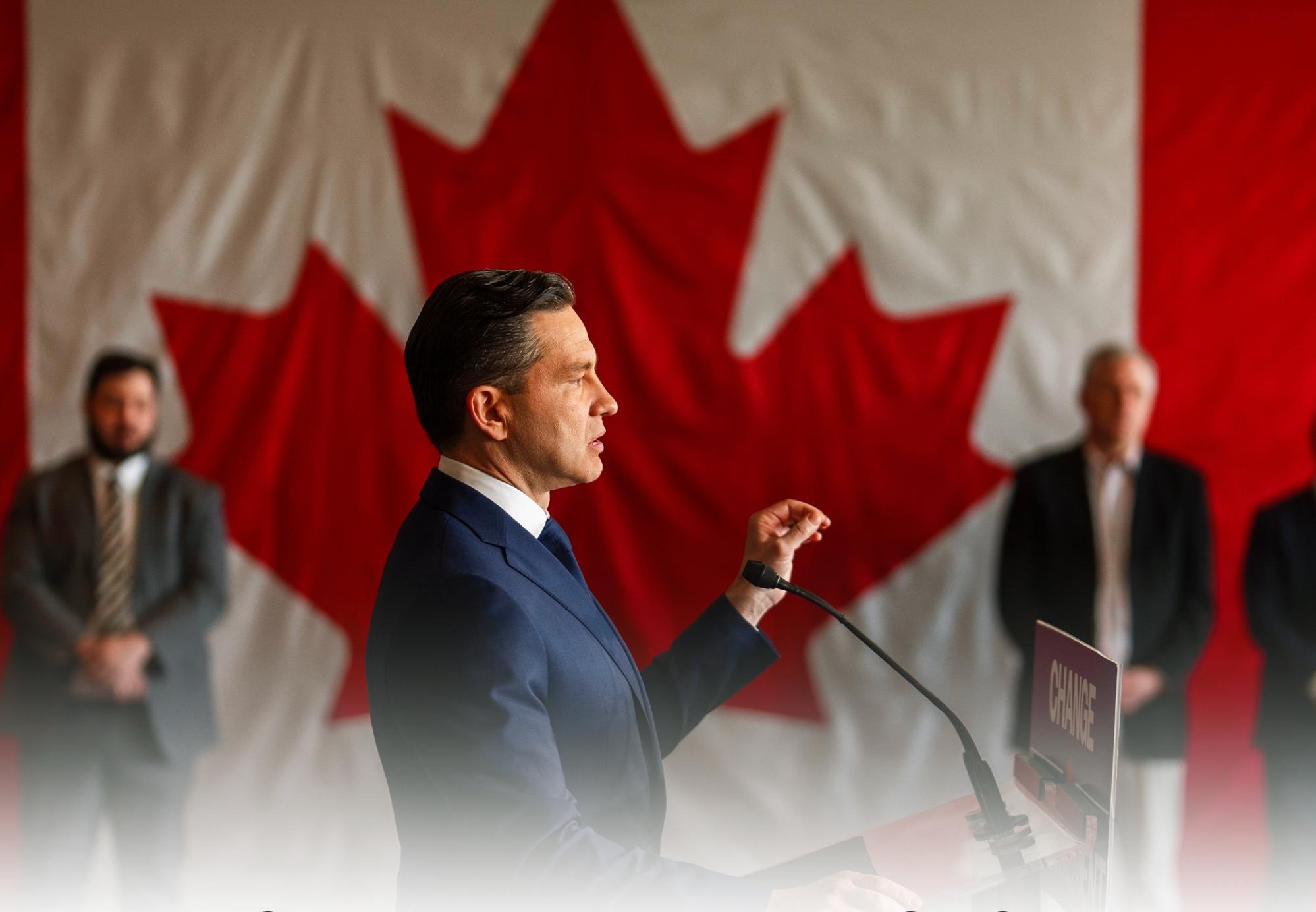Pierre Poilievre standing in profile with a large Canadian Flag as the background. From the Conservative Party homepage.